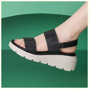 Detail of wedge sandals showing rhinestone straps and thick sawtooth anti-slip sole