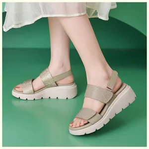 Detail of rhinestone straps and platform wedge sole on women's olive green sandals