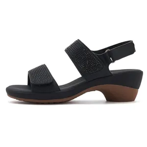 Detail view of black rhinestone straps and velcro closure on women's wedge sandals