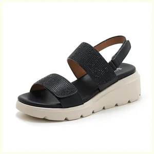 Detail of wedge sandals with rhinestone straps and anti-slip platform sole