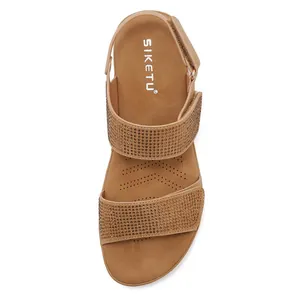 Detail view of khaki wedge sandals with rhinestone straps and adjustable velcro strap