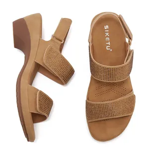Detail of rhinestone straps and wedge heel on khaki wedge sandals with velcro strap