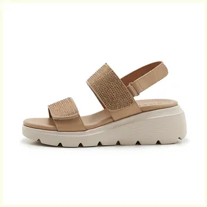 Detail view of rhinestone-embellished wedge sandals with non-slip wavy soles in beige