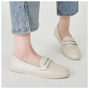 On-foot view of beige leather loafers with almond toe and casual cutout strap detail