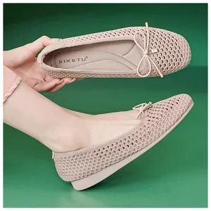 Detail of pink woven flats featuring breathable mesh and delicate bow with metal pendant