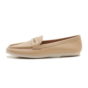 Detailed side view of beige leather loafer with classic penny strap and soft flat sole
