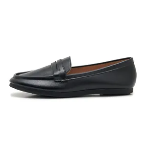 Close-up side view showing fine leather texture and classic strap of black penny loafers