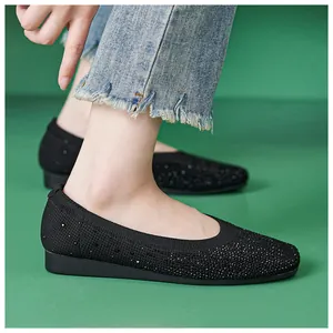 Close-up of black flying woven flat shoes for women with sparkling rhinestone details
