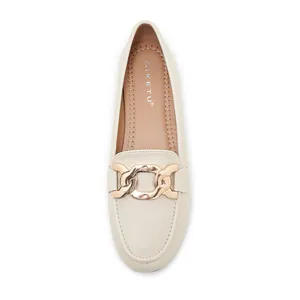 Close-up of cream loafers featuring gold chain link hardware and SIKETU branded insole