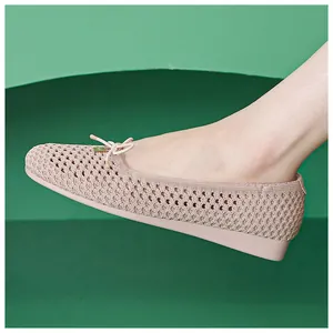 Detail of pink woven ballet flats with delicate bow and hollow breathable texture
