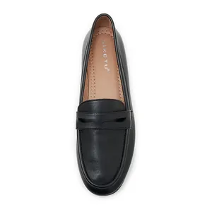 Detailed top view of matte black leather loafers with soft cushioned tan insoles