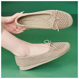 Detail of breathable hollow mesh ballet flats with beige bow and gold charm pendant