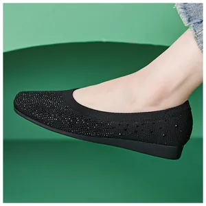 Detail of black knit ballet flats featuring shimmering rhinestones and soft elastic collar