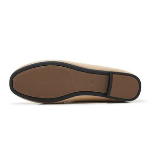 Macro detail of brown rubber anti-slip sole with size mark on beige loafers