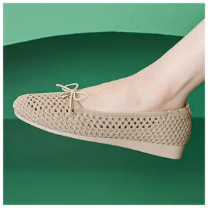 Detail of breathable knitted mesh ballet flats with a delicate bow on model's foot