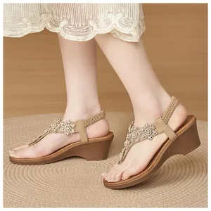 Detailed view of women's wedge sandals featuring floral rhinestone beadwork and elastic back strap
