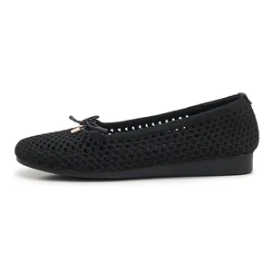 Macro view of black woven texture and delicate bow detail on lightweight flat shoes