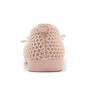 Close-up of pink breathable knitted mesh fabric and reinforced heel of flat shoes