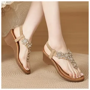 Detail view of rhinestone floral embellishments on wedge sandals with beaded accents