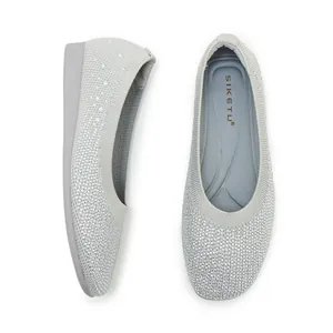 Detail view showing gray knitted fabric with sparkling silver rhinestones on ballet flats