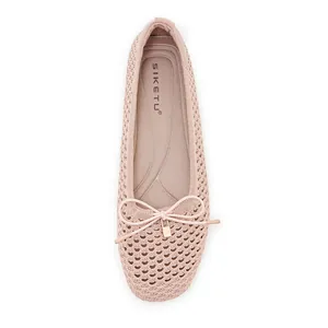 Detail of pink knitted mesh ballet flats with bow and gold lock pendant decoration