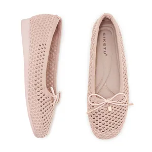 Detail of light pink knitted mesh ballet flats with bow and gold lock pendant