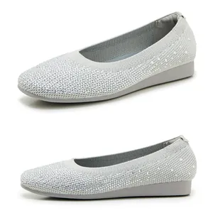 Detail of light gray knitted flats with sparkling rhinestone embellishments and flat sole