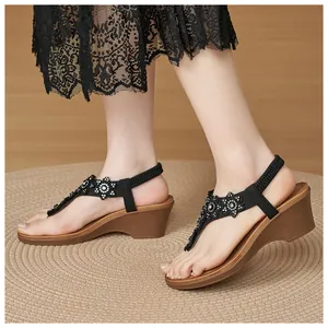 Detail of wedge sandals with rhinestone flowers and comfortable elastic heel strap