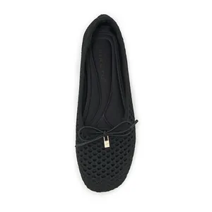 Detailed top view of black hollow mesh flat shoes with elegant bow and brand insole