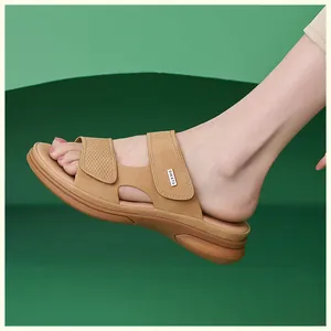Side view of woman wearing tan nubuck leather wedge sandals on a green background