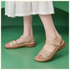 Detail of khaki wedge sandals with micro-rhinestone embellishments on cutout straps