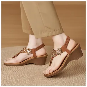 Detail of wedge sandals with rhinestone flower charms and brown T-strap design