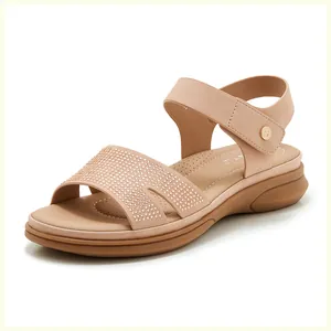 Close-up of rhinestone strap and ergonomic wedge sole on women's vintage sandals