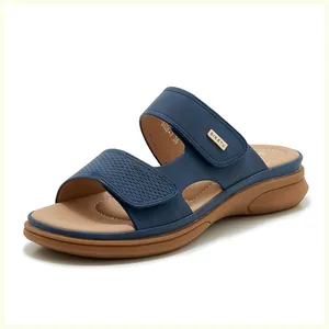 Close-up of dark blue wedge sandals with woven texture straps and Velcro adjustment