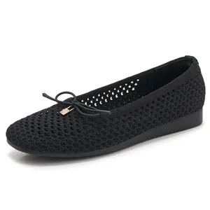 Women's black knit hollow flat shoes with elegant bow and golden lock charm detail