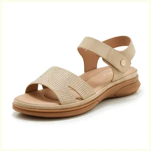 Close-up of sparkling rhinestones on khaki wedge sandals with adjustable ankle strap