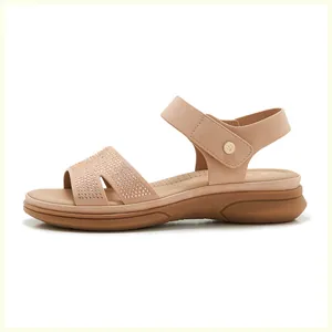 Detail view of rhinestone wedge sandals with velcro strap and metallic buckle