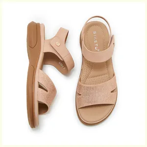 Close-up of beige platform sandals with rhinestone straps and breathable insoles