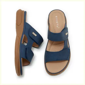 Detail view of woven blue straps and breathable brown cushioned insole of platform sandals