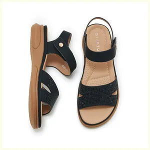 Close-up of black strap with sparkling rhinestones and comfortable flat sole detail