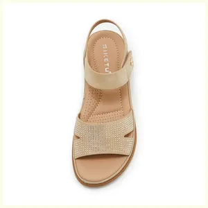 Detailed close-up of beige sandals with sparkling rhinestones and cushioned SIKETU insole