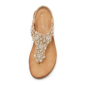 Detail of nude rhinestone flower lace sandals with comfortable elastic heel strap