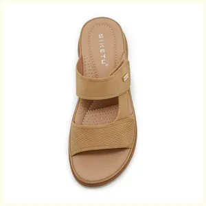 Top view of brown wedge sandals with woven straps and detailed stitching on the footbed