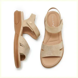 Detail of wedge sandals showing rhinestone strap embellishments and comfort footbed
