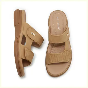Detail of camel wedge sandals with textured woven straps and golden logo plate decoration