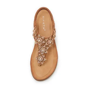 Detail of khaki thong sandals with rhinestone flowers and elastic heel strap