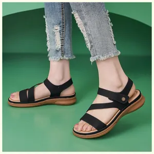 Detail of black multi-strap wedge sandals with metal buckle and comfortable thick sole