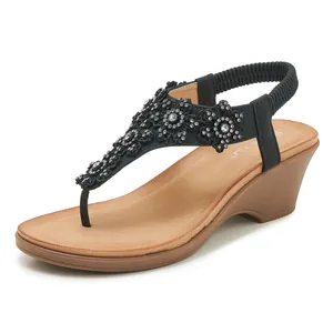 Black wedge sandals with rhinestone floral embellishments and elasticated back strap