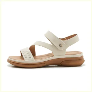 Detailed macro view of wedge sandals featuring laser-cut patterns and velcro ankle straps