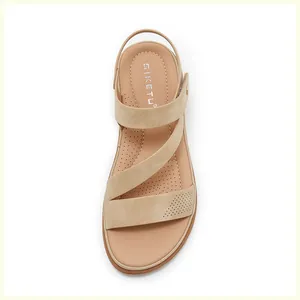 Detailed top view of beige cross-strap sandals featuring a cushioned breathable footbed